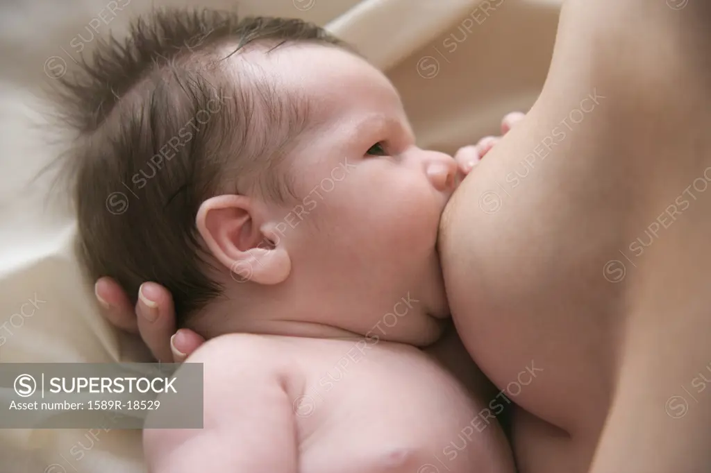 Close up of mother breast feeding her baby