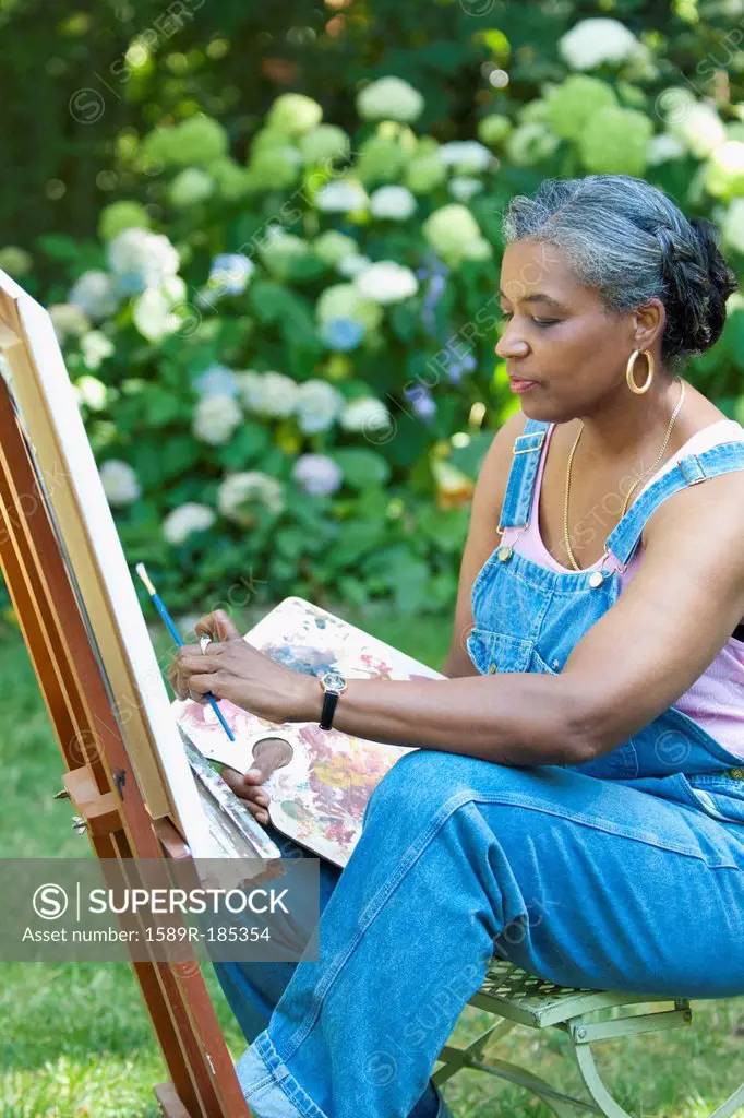 Black artist painting outdoors