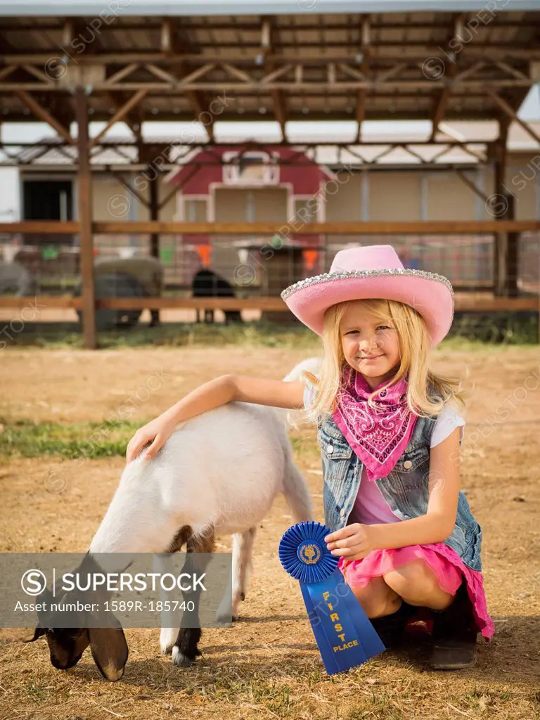 Caucasian girl with prize winning goat on farm