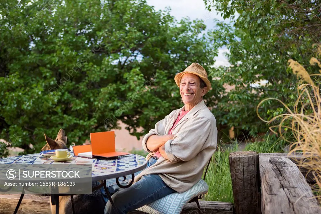 Caucasian man sitting at table outdoors