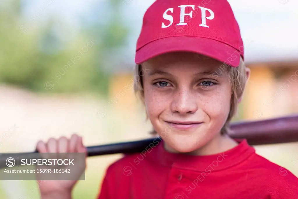 Caucasian boy playing baseball outdoors