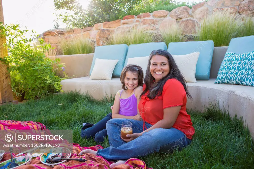 Mother and daughter eating outdoors