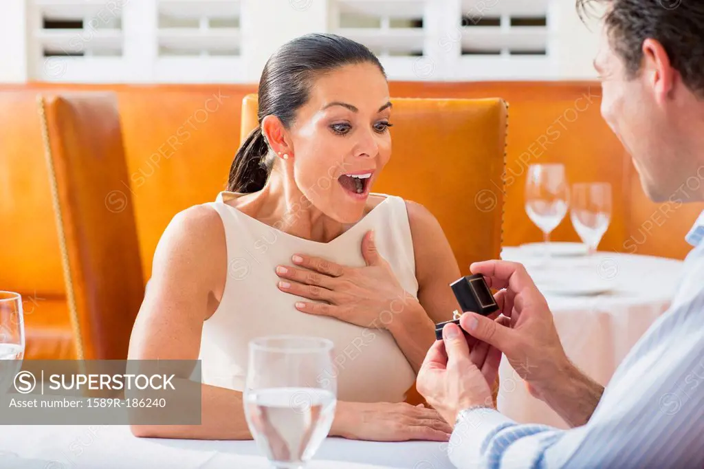 Man proposing to girlfriend at restaurant