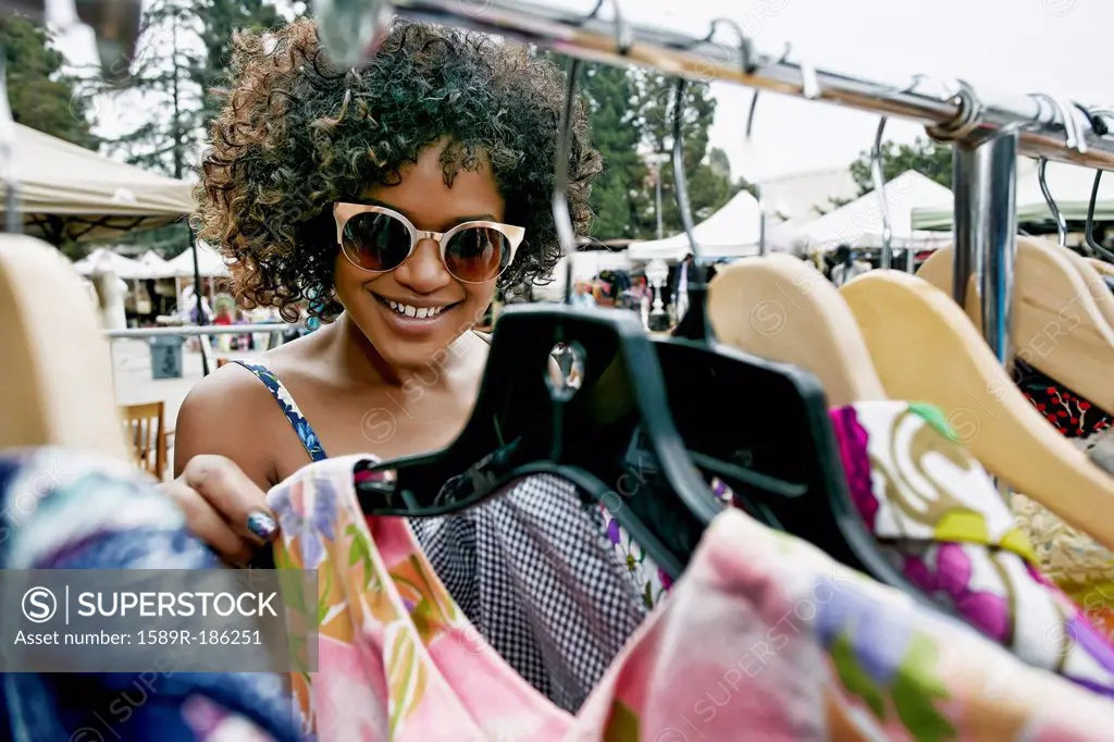 Mixed race woman shopping at flea market