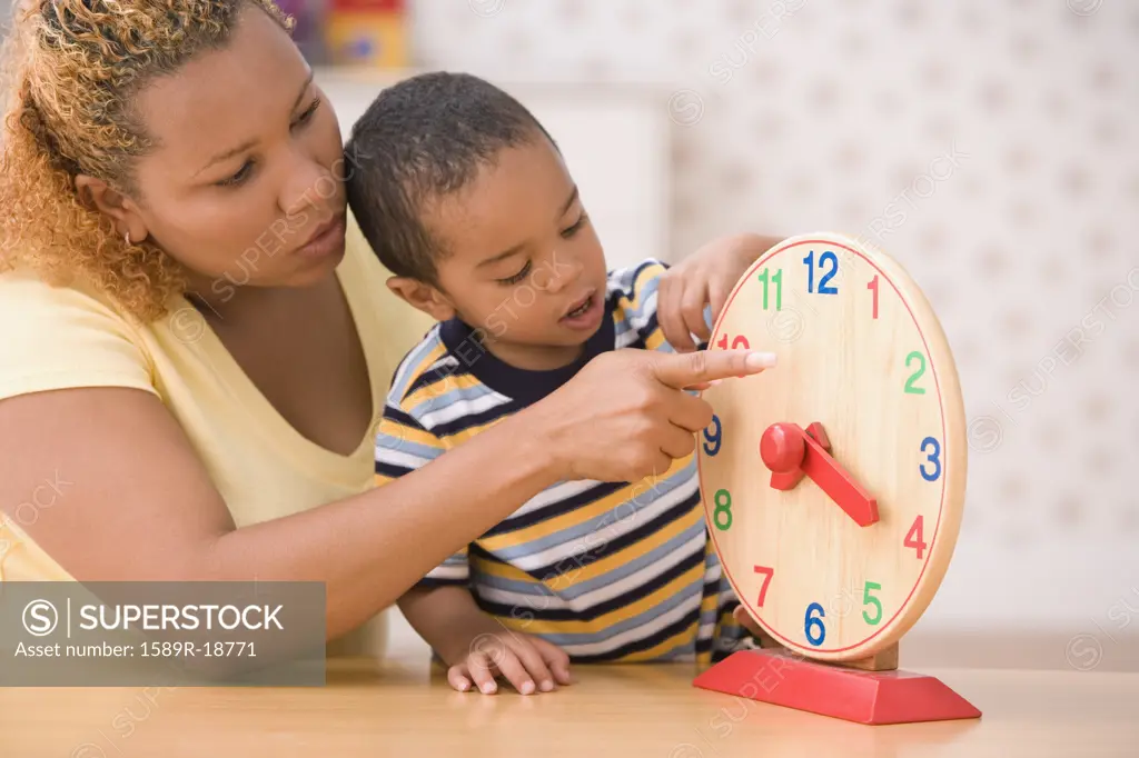 Mother teaching son to tell time