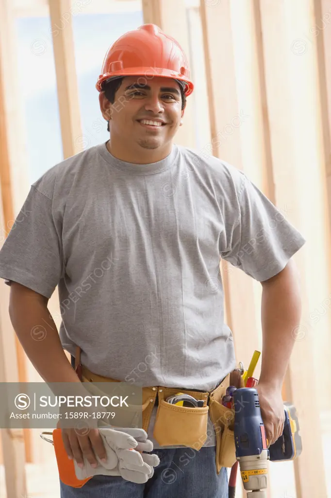 Portrait of construction worker in hard hat and tool belt