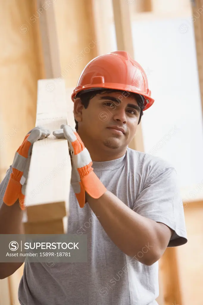 Portrait of construction worker carrying 2x4ís on shoulder
