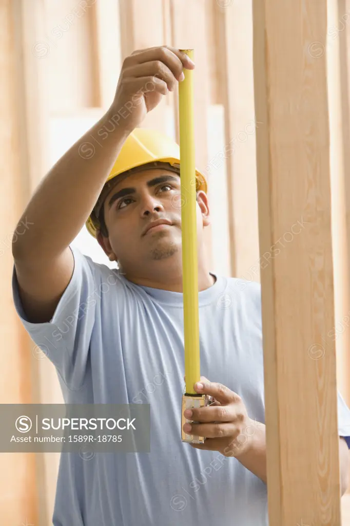 Construction worker with measuring tape
