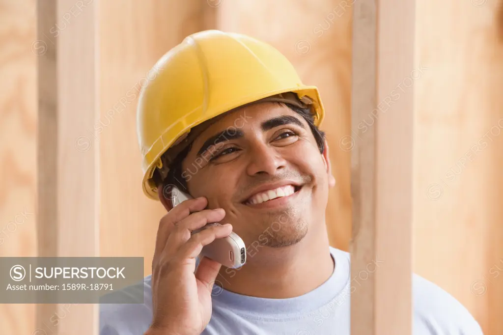 Close up of construction worker talking on cell phone