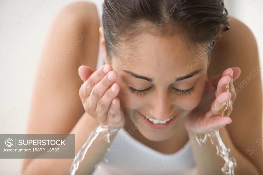 Close up of woman washing face