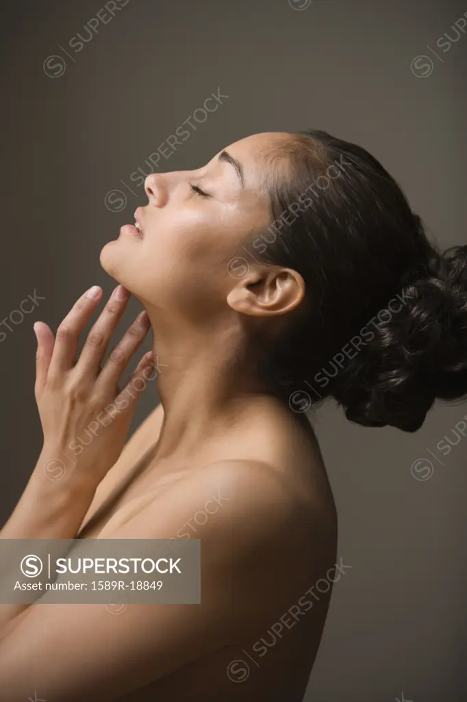 Profile of woman with eyes closed and hand under chin