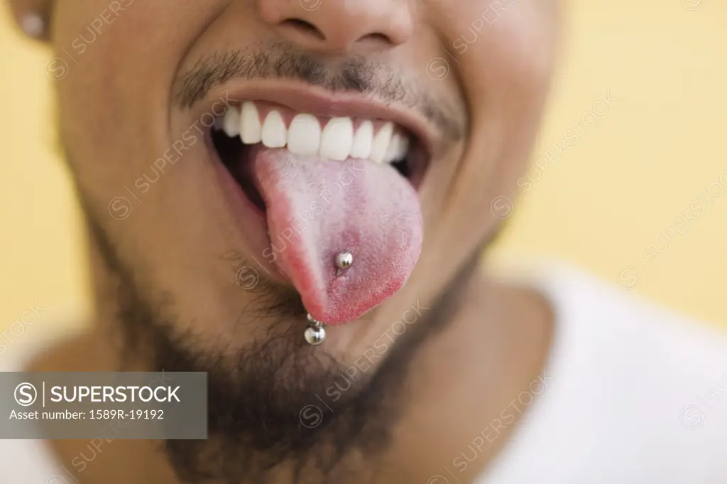 Young man showing off his tongue ring