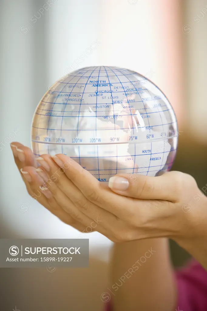 Woman holding a plastic globe