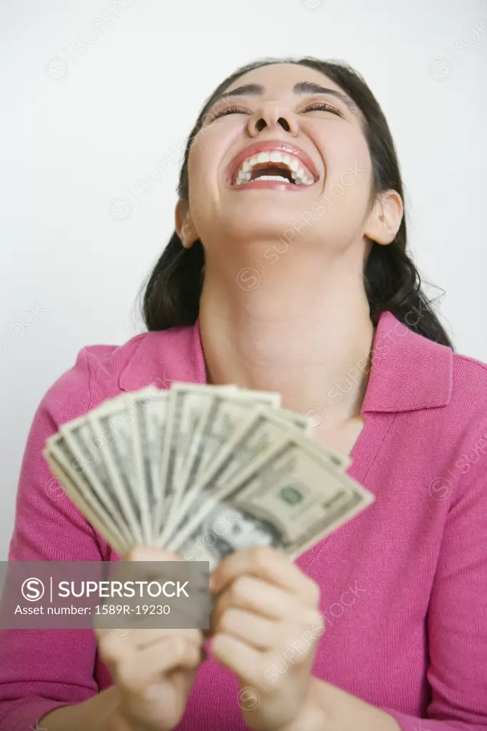 Woman holding out fan of money