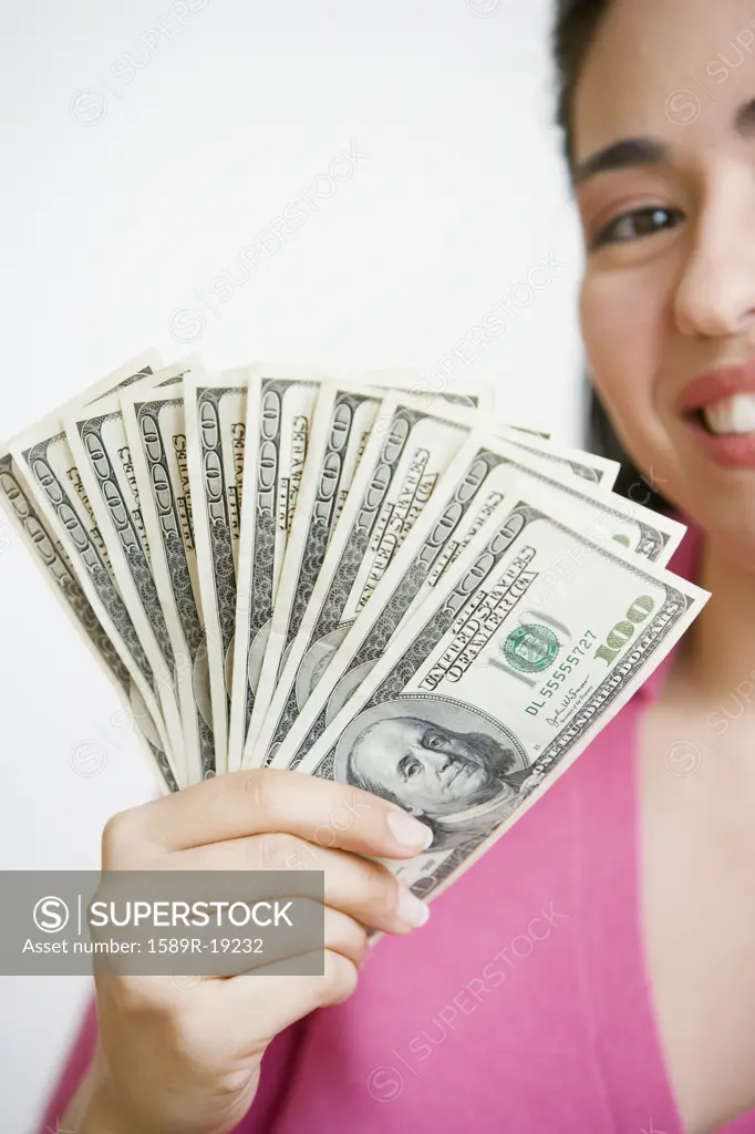 Woman holding out fan of money