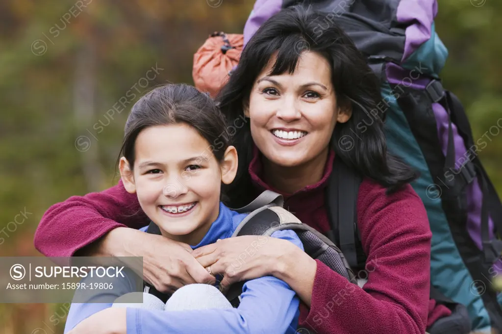 Mother and daughter smiling together outdoors