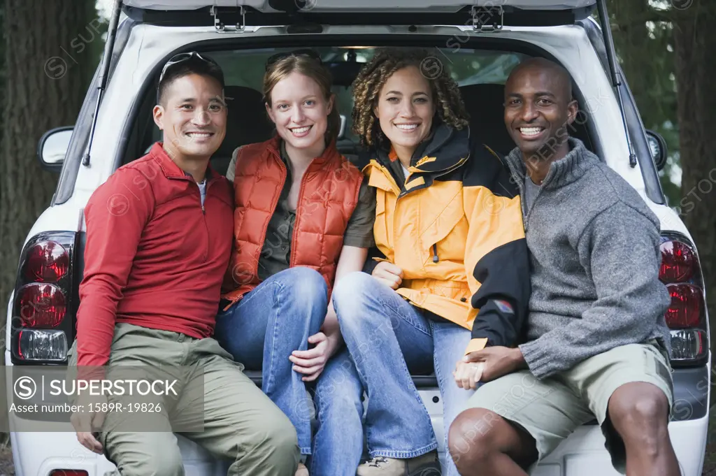 Friends sitting in the trunk of an SUV