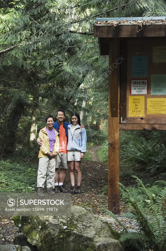 Portrait of family posing on hiking trail