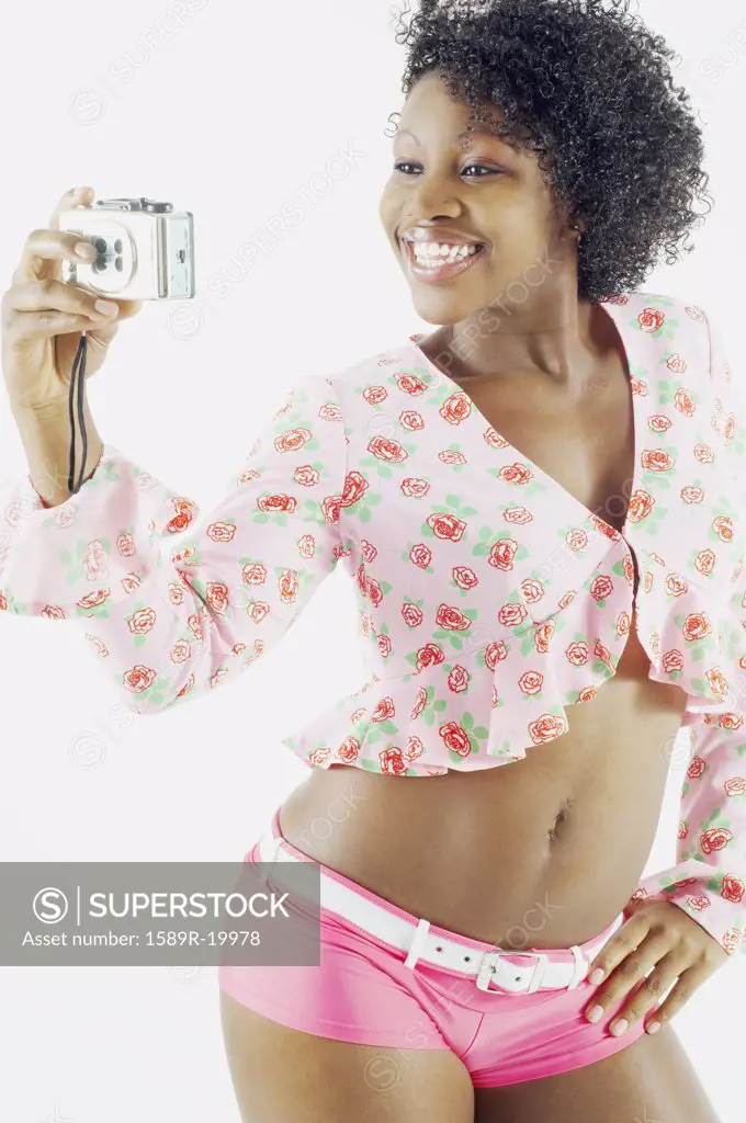 Woman taking self portrait with camera