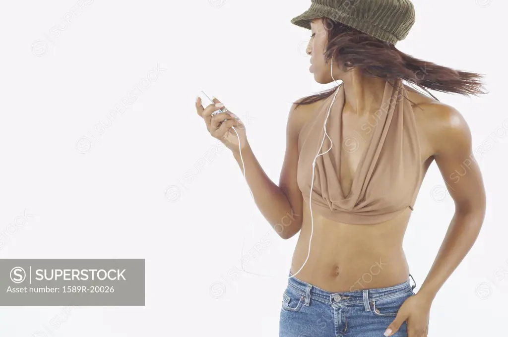 Young woman dancing while listening to an mp3 player