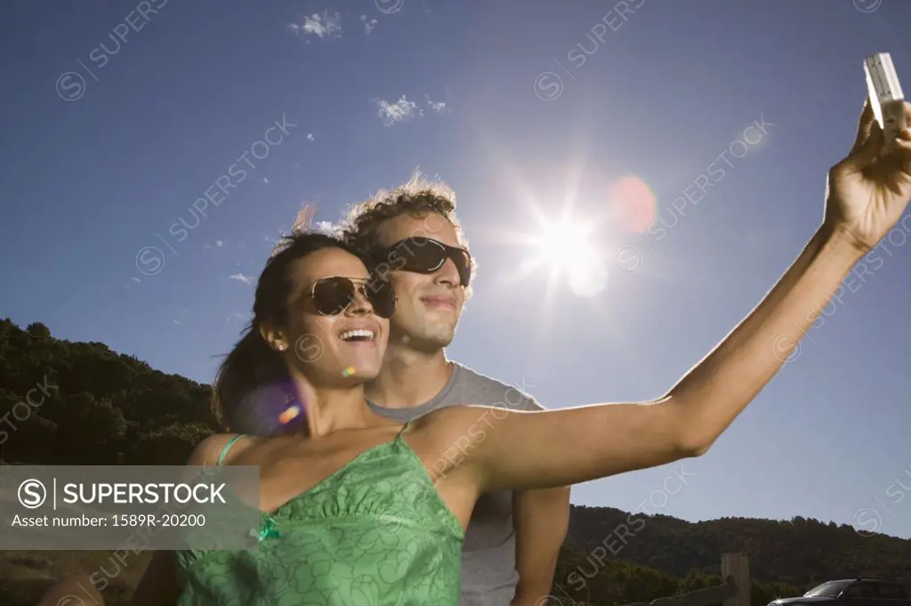 Couple taking self-portrait with camera