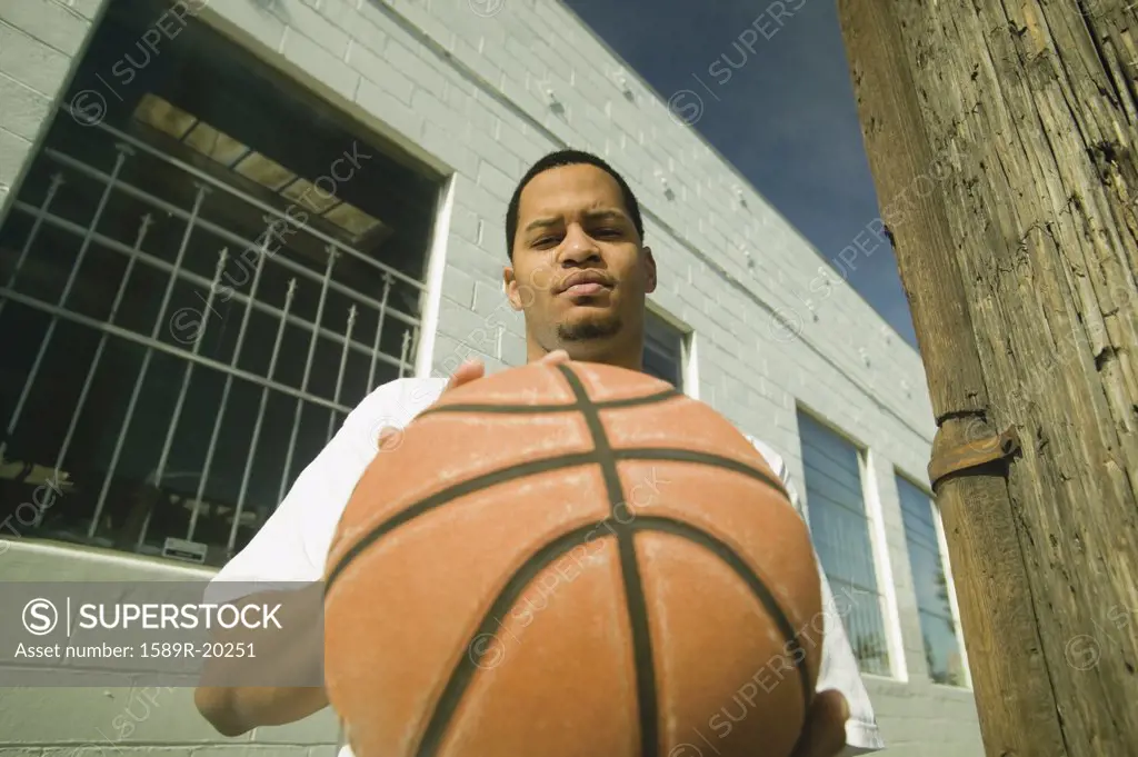 Young man bouncing a basketball