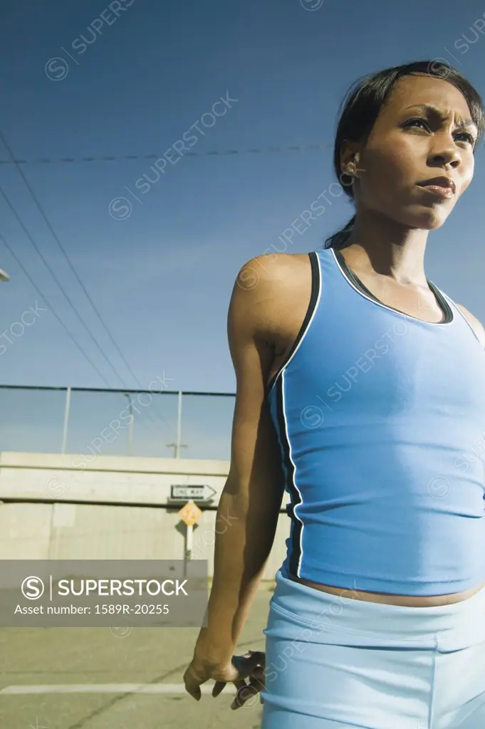 Female athlete stretching in urban surroundings