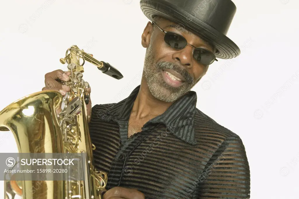 Middle aged man playing the saxophone