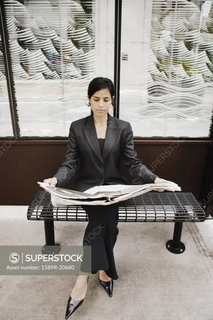 Businesswoman reading a newspaper