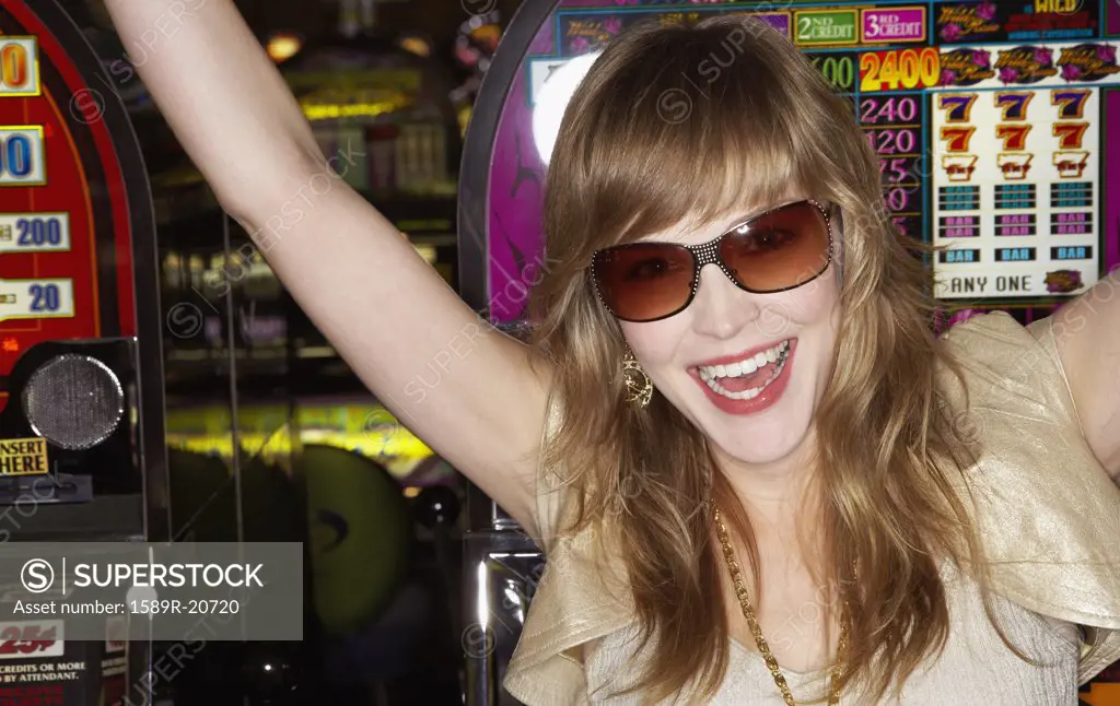 Young woman wearing sunglasses in a casino