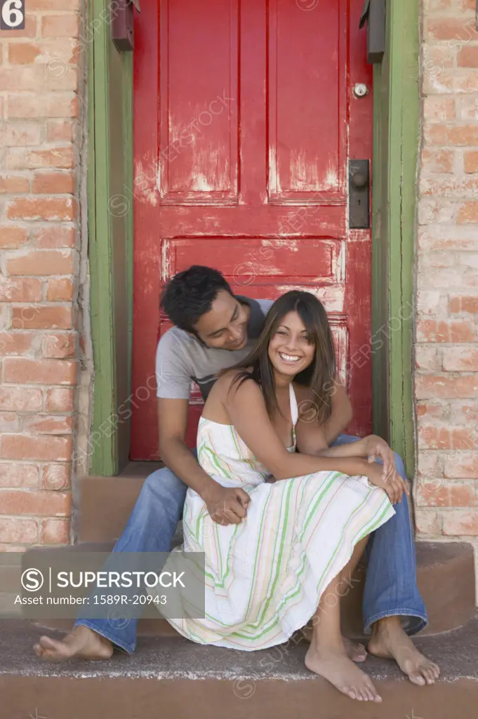 Couple hanging out on a doorstep