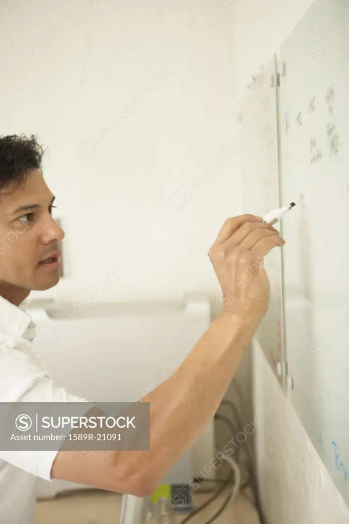 Young businessman writing on a whiteboard