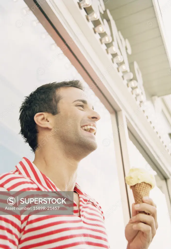 Young man eating an ice cream cone