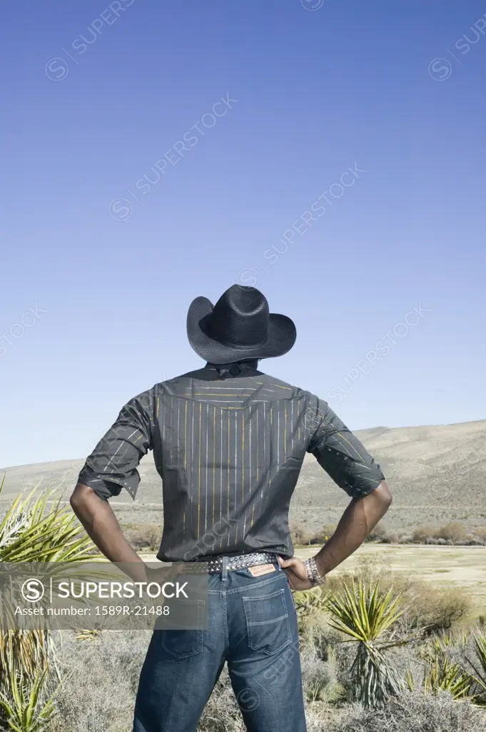 Young man in cowboy outfit posing for the camera