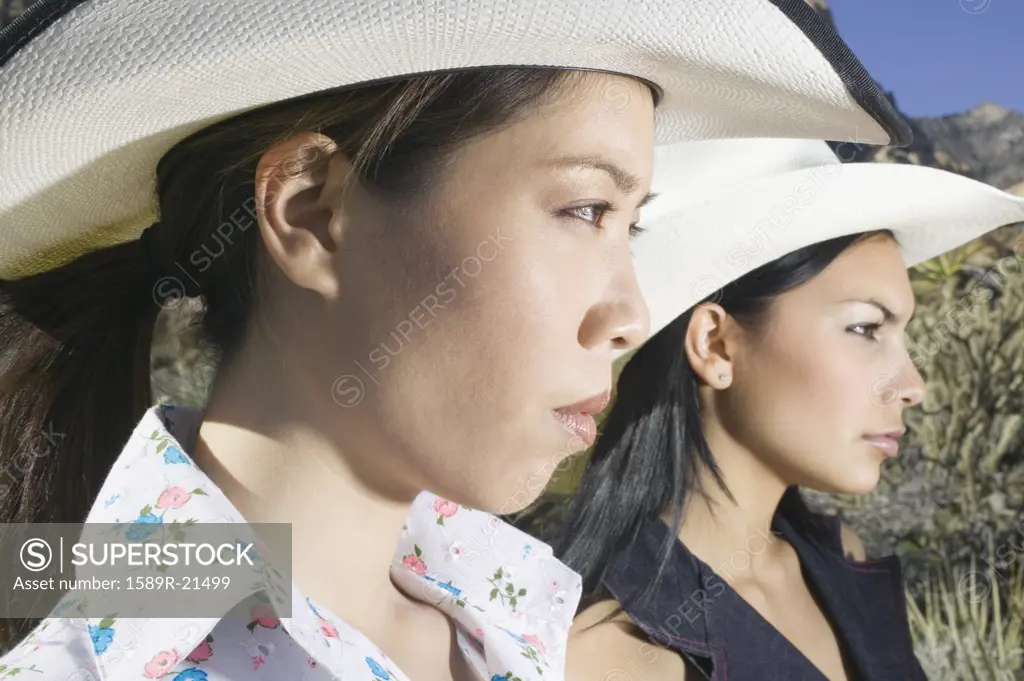 Young women in cowboy outfits posing for the camera