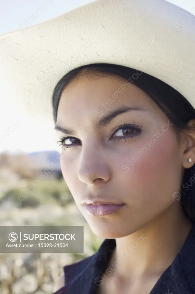 Young woman in cowboy hat posing for the camera