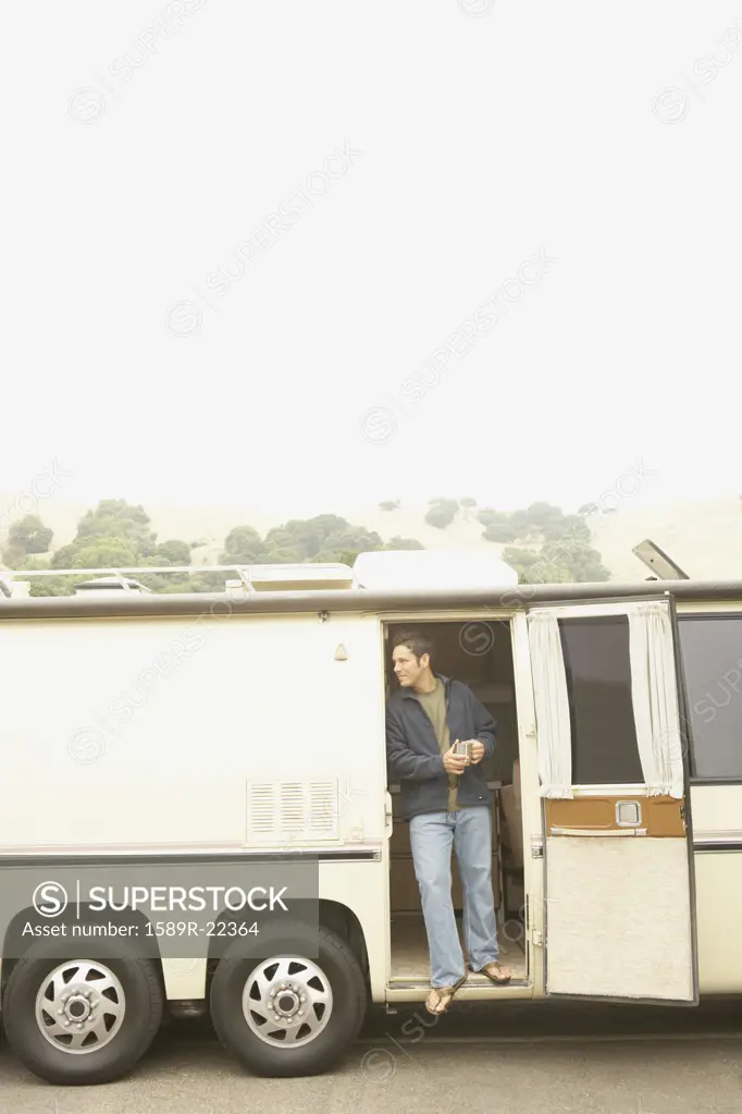 Man standing in doorway to recreational vehicle
