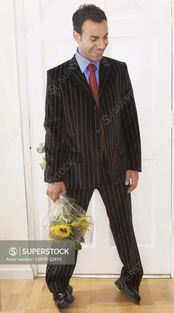 Businessman holding a bunch of flowers