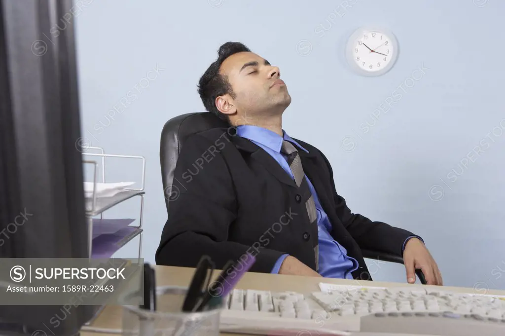 Businessman asleep at his desk