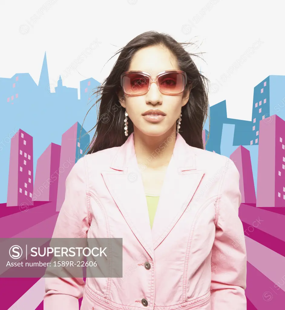 Woman posing for the camera in sunglasses against city background