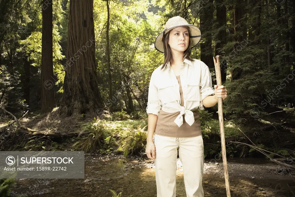 Explorer standing in forested area
