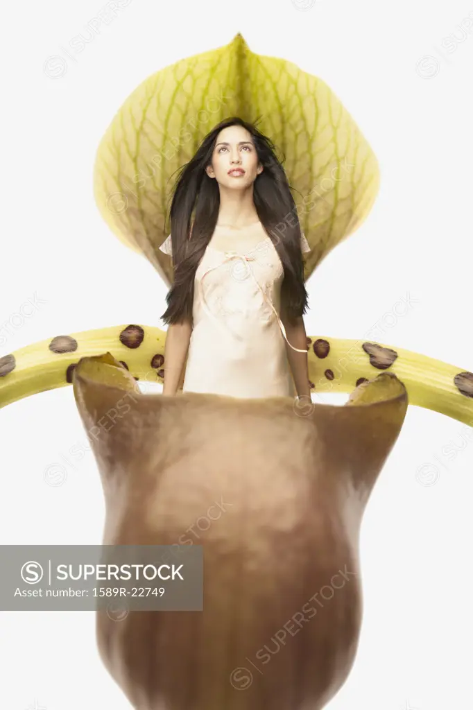 Young woman sitting in a giant plant