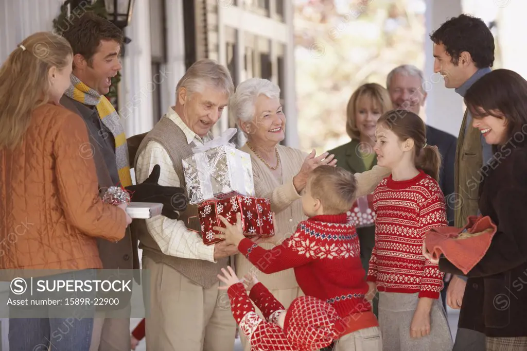 Children giving presents to their grandparents outdoors, Richmond, Virginia, United States