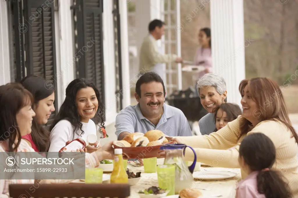Hispanic family eating dinner outdoors, Richmond, Virginia, United States