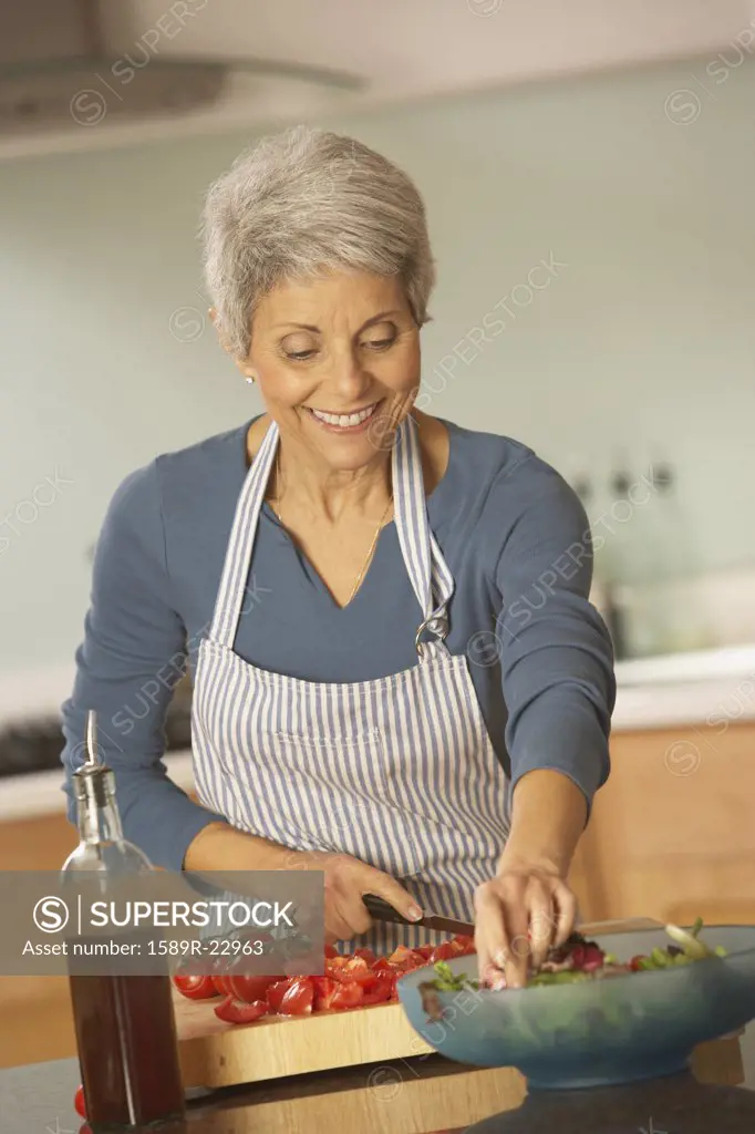 Hispanic grandmother making salad, Richmond, Virginia, United States