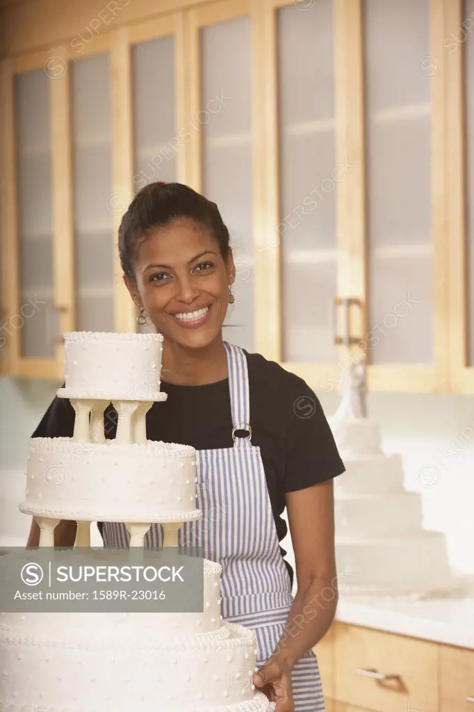 African female baker next to a wedding cake, Richmond, Virginia, United States