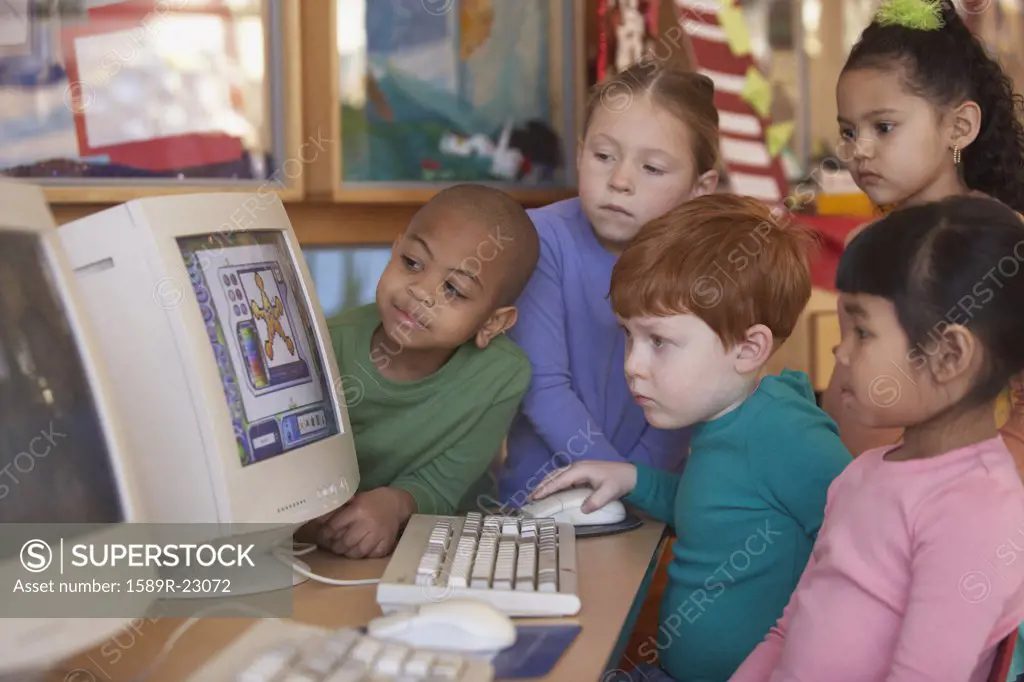 Group of young children looking at computer