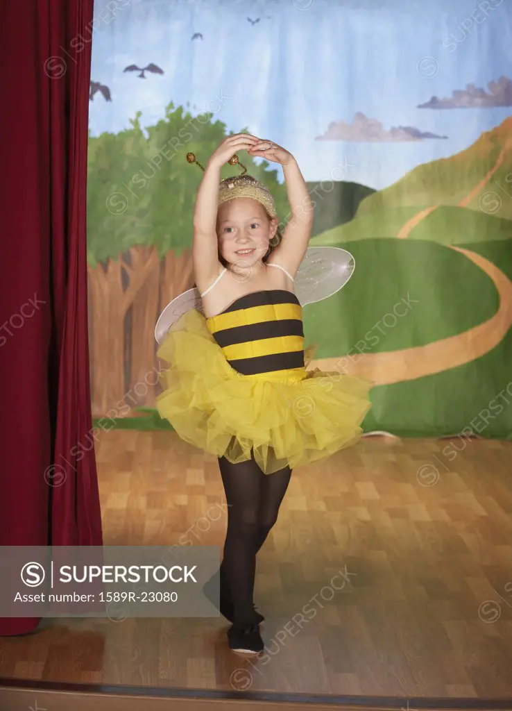 Young girl in bee costume on stage