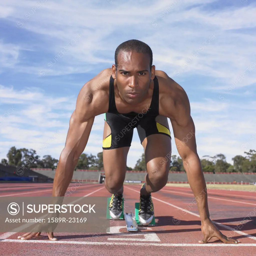 African male athlete in starting position on track, Perth, Australia
