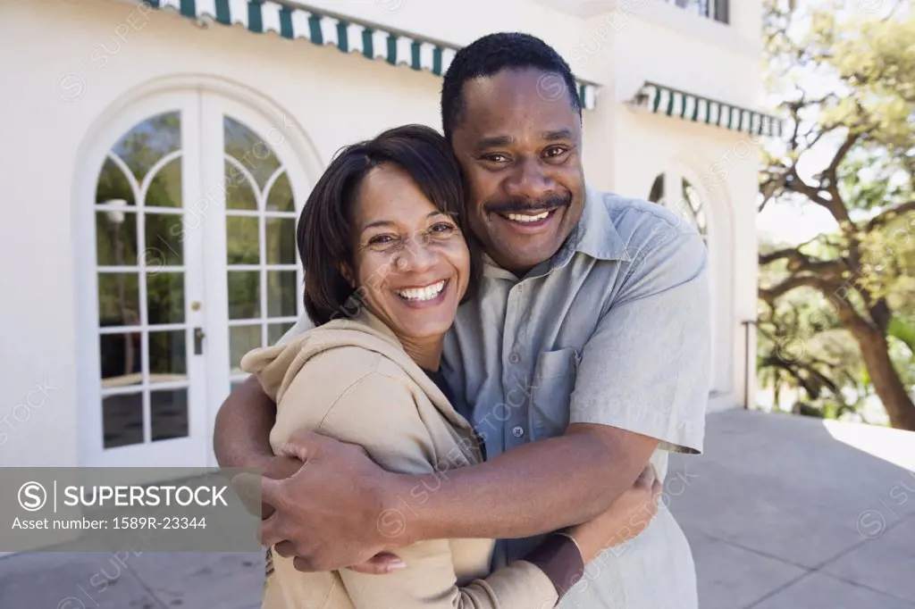 African American couple hugging outdoors